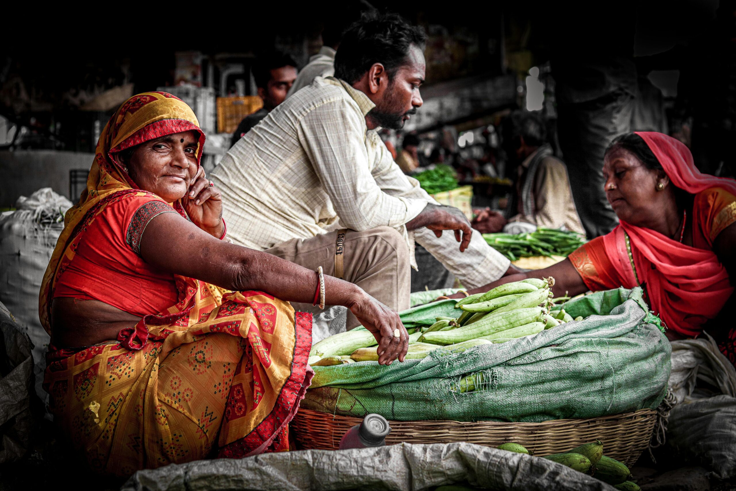 Vibrant Indian market scene showcasing vendors in traditional attire selling fresh vegetables.