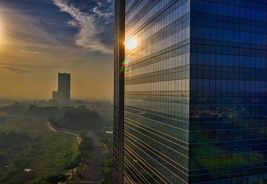 Aerial view of modern skyscrapers reflecting the sunrise in Banten, Indonesia, showcasing urban architecture.