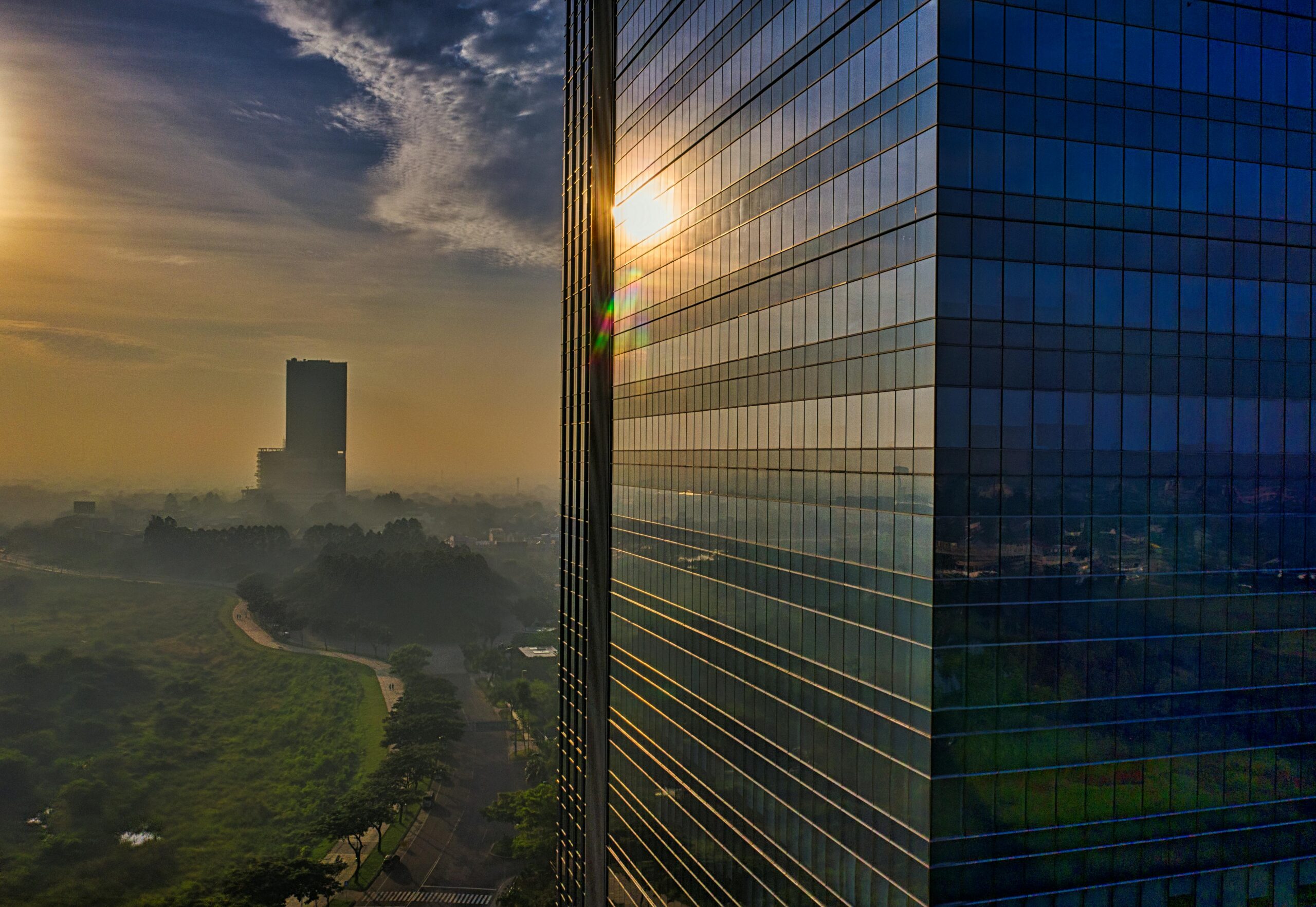 Aerial view of modern skyscrapers reflecting the sunrise in Banten, Indonesia, showcasing urban architecture.